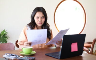 Employee reviewing invasive discovery requests, deposition papers, and documents in a wrongful termination and employment discrimination lawsuit.