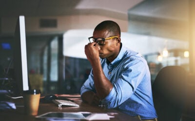 Black employee at an office desk reviewing a large race discrimination jury verdict and damages award.